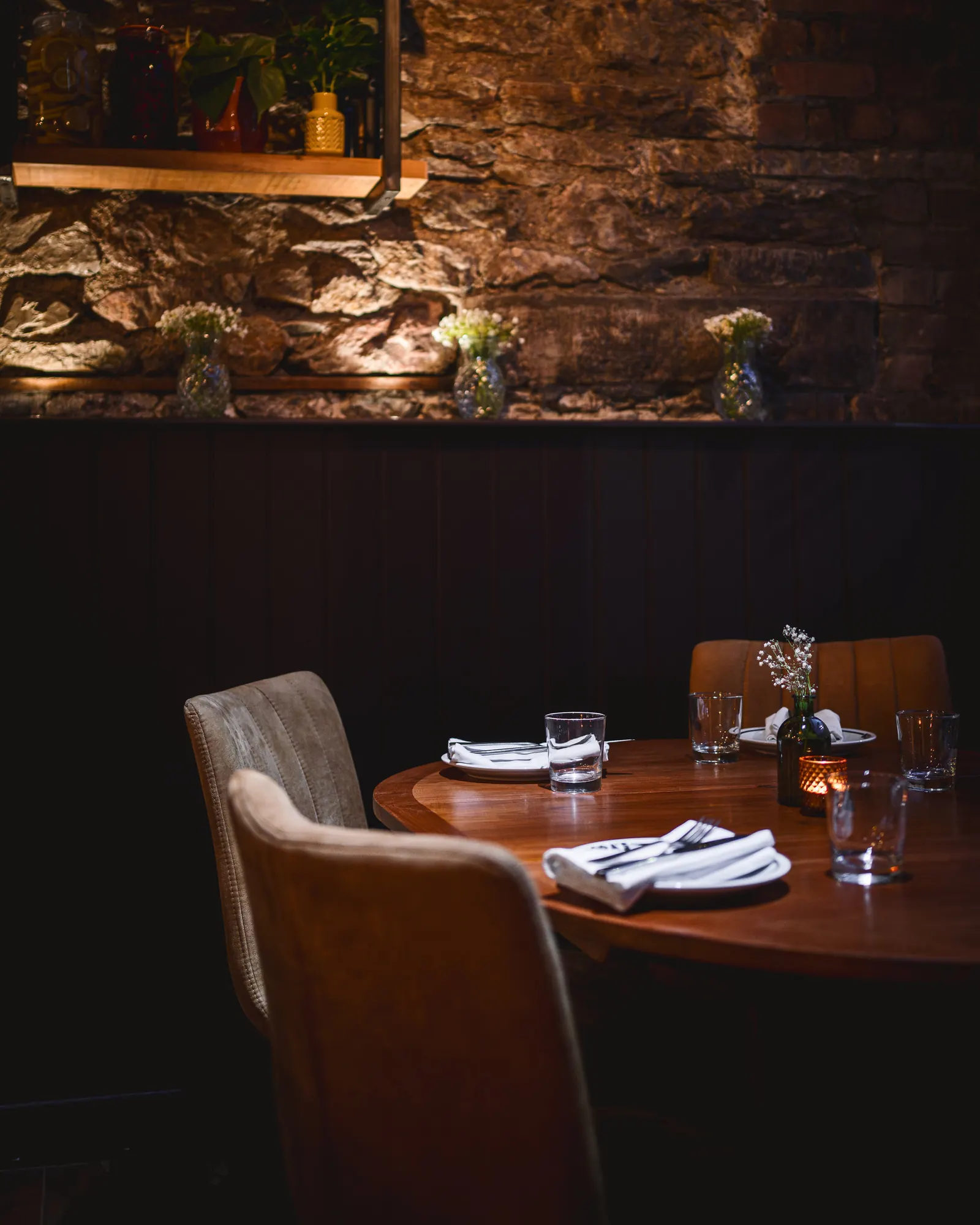 Table set for dinner beside the stone wall at NORA'S