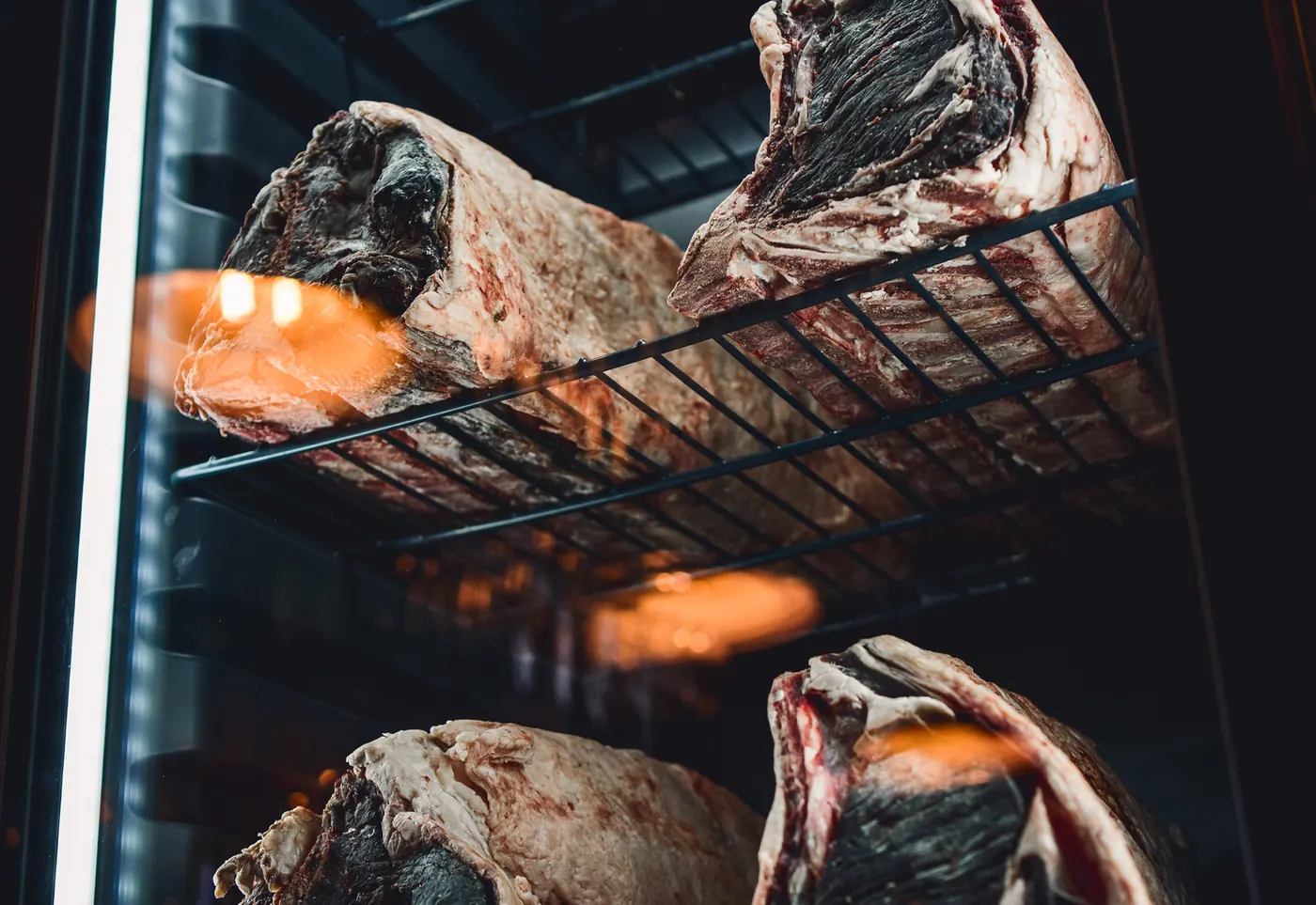Cuts of beef hanging in the house dry ager